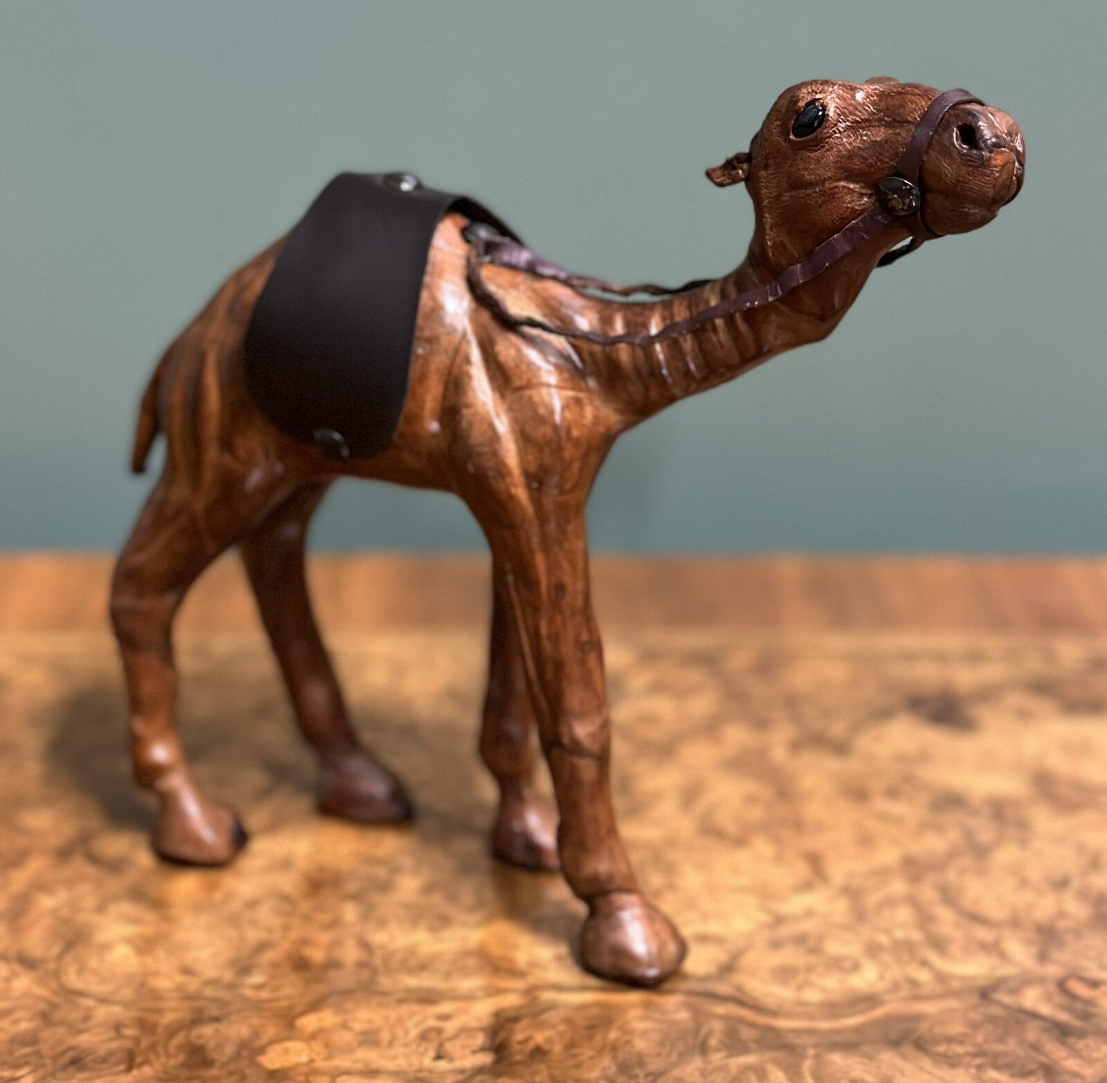 CAMEL SCULPTURE WITH LOVELY AGED LEATHER ON HAND CARVED WOOD BY LIBERTYS LONDON