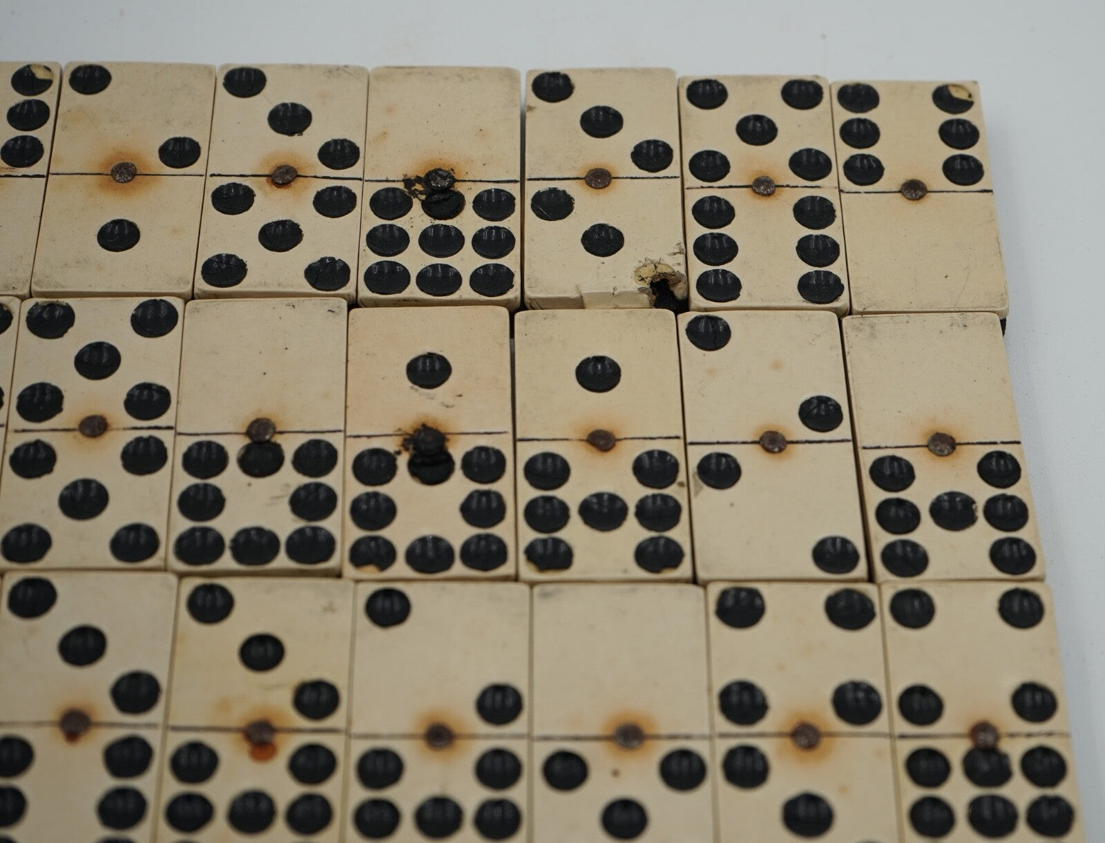 LATE 19TH CENTURY BOX OF TRADITIONAL GAME NINER DOMINOS WITH STUNNING PATINA