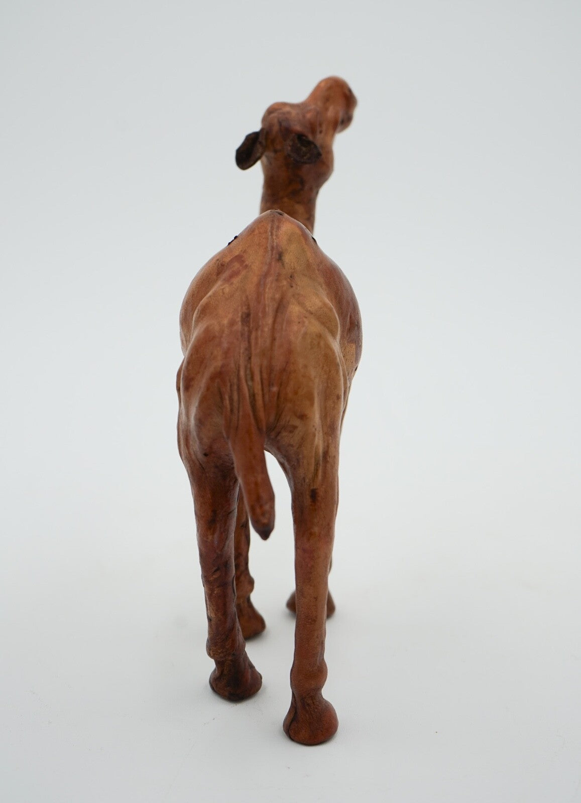 CAMEL SCULPTURE WITH  AGED LEATHER ON HAND CARVED WOOD BY LIBERTY'S LONDON