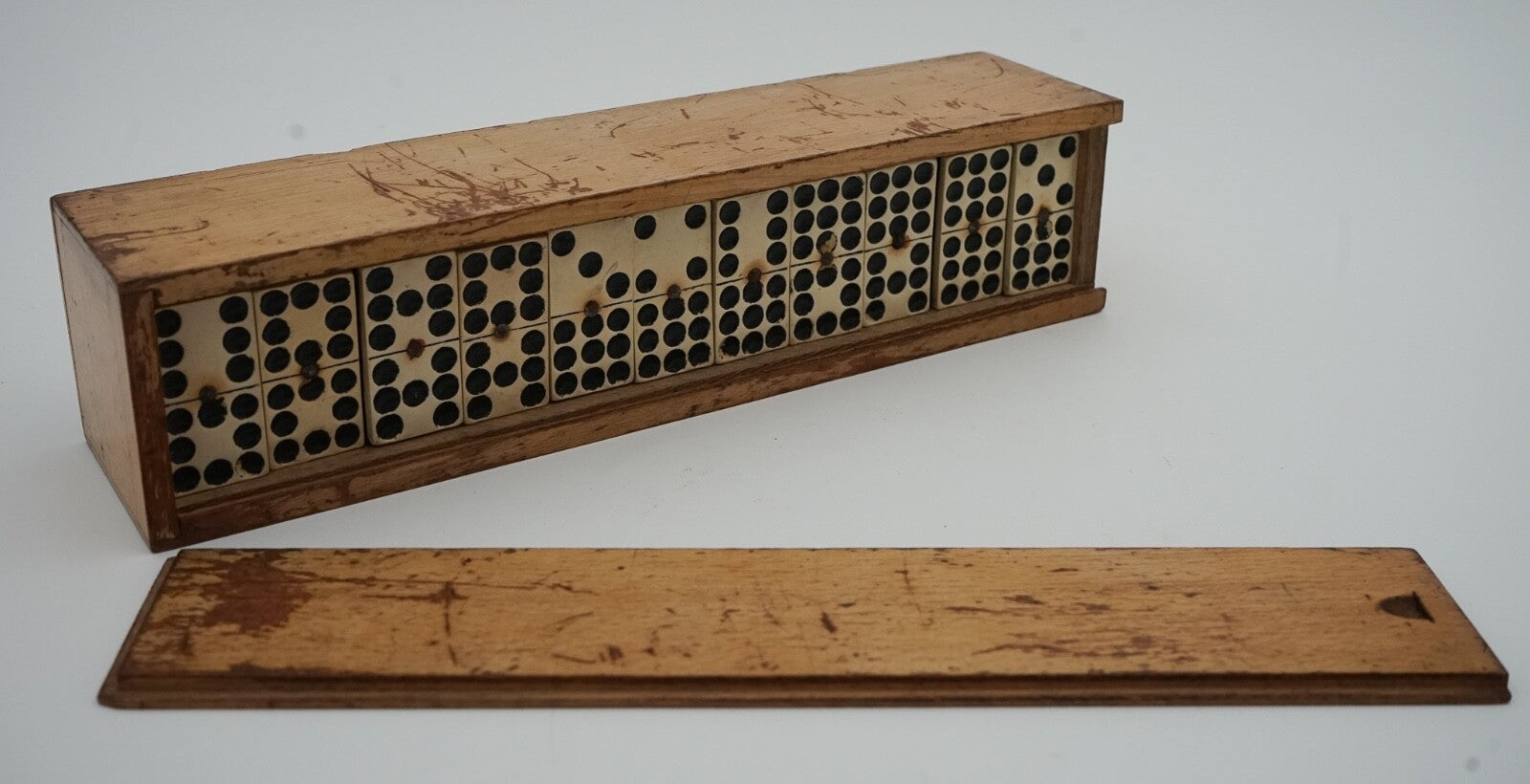 LATE 19TH CENTURY BOX OF TRADITIONAL GAME NINER DOMINOS WITH STUNNING PATINA