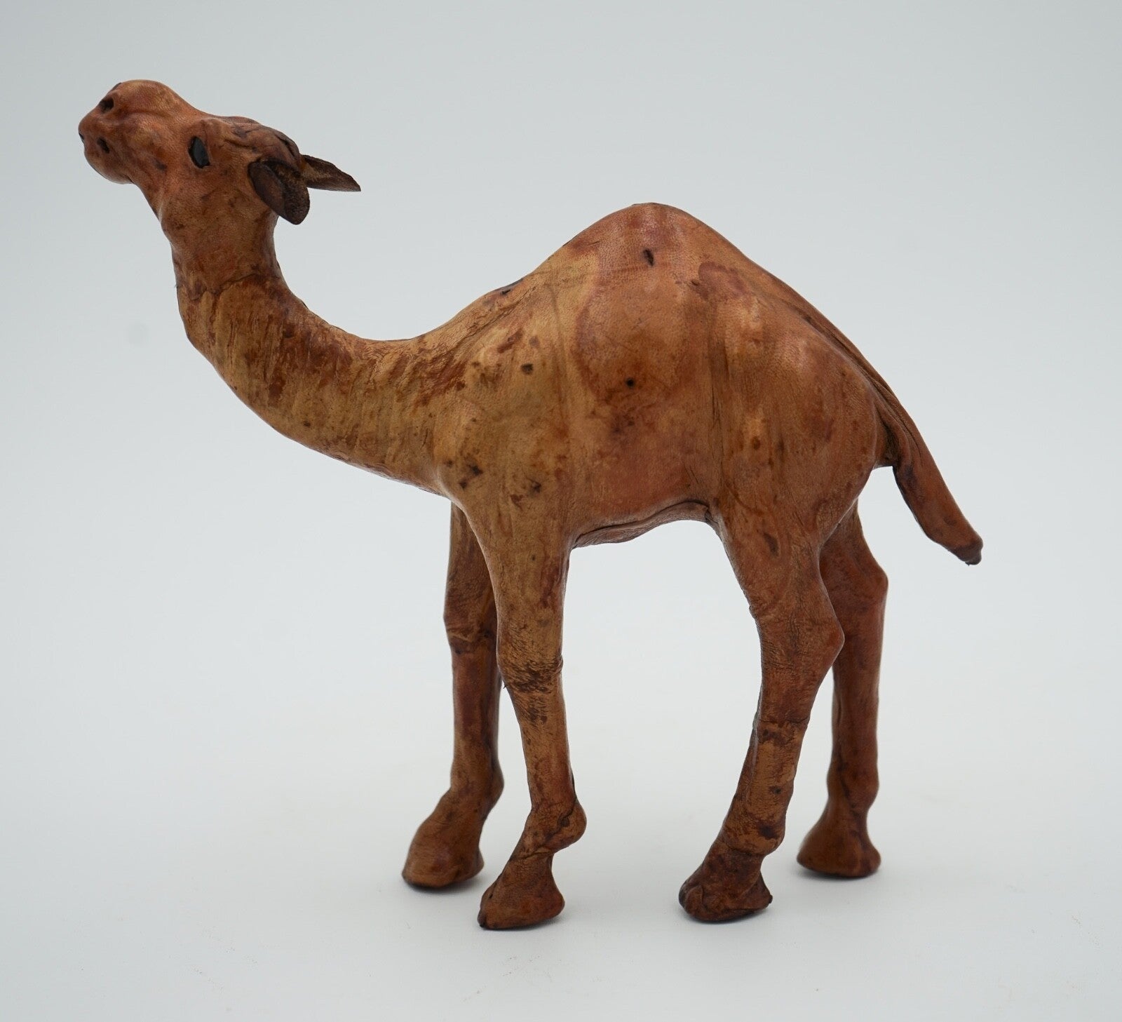 CAMEL SCULPTURE WITH  AGED LEATHER ON HAND CARVED WOOD BY LIBERTY'S LONDON