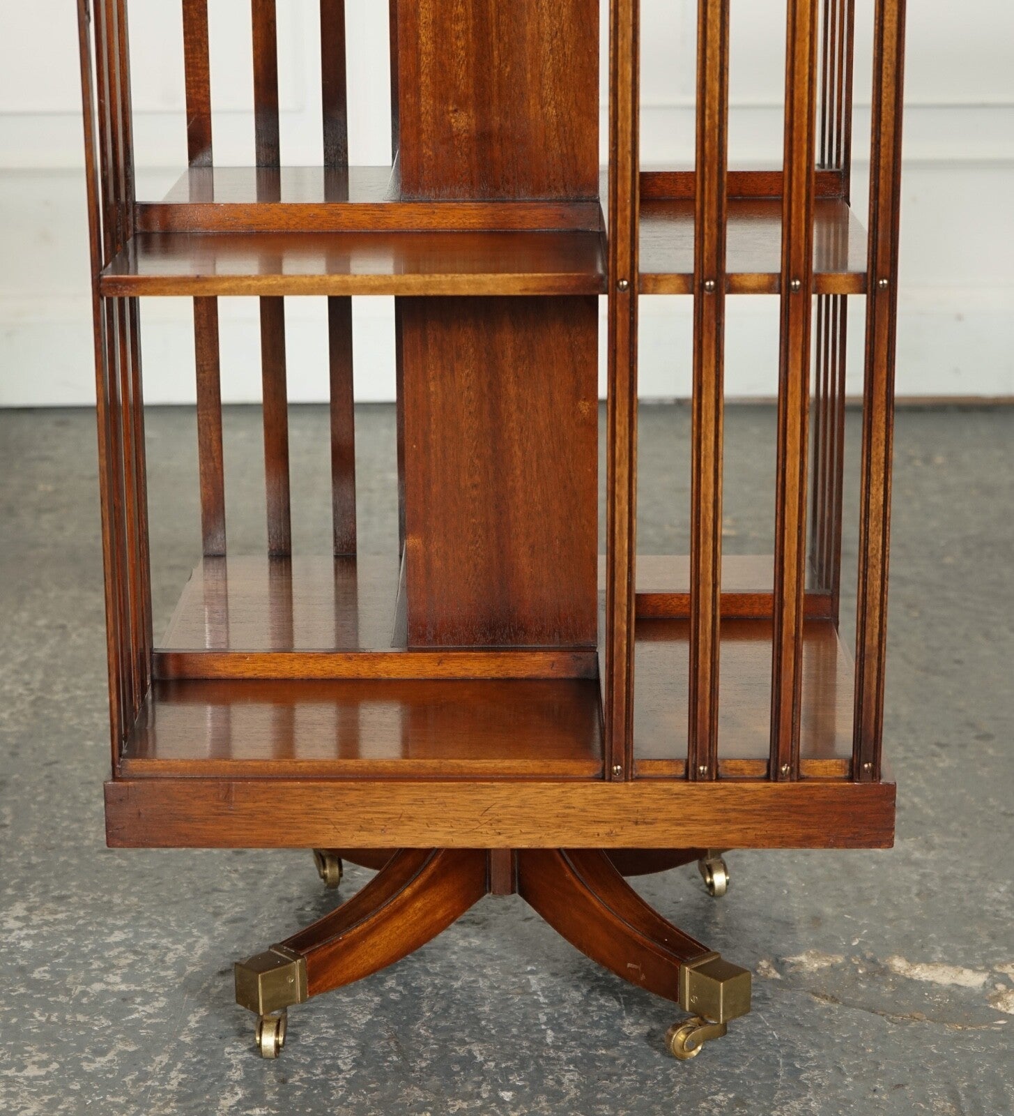 BEVAN FUNNEL REVOLVING BOOKCASE END TABLE RAISED ON BRASS CASTORS