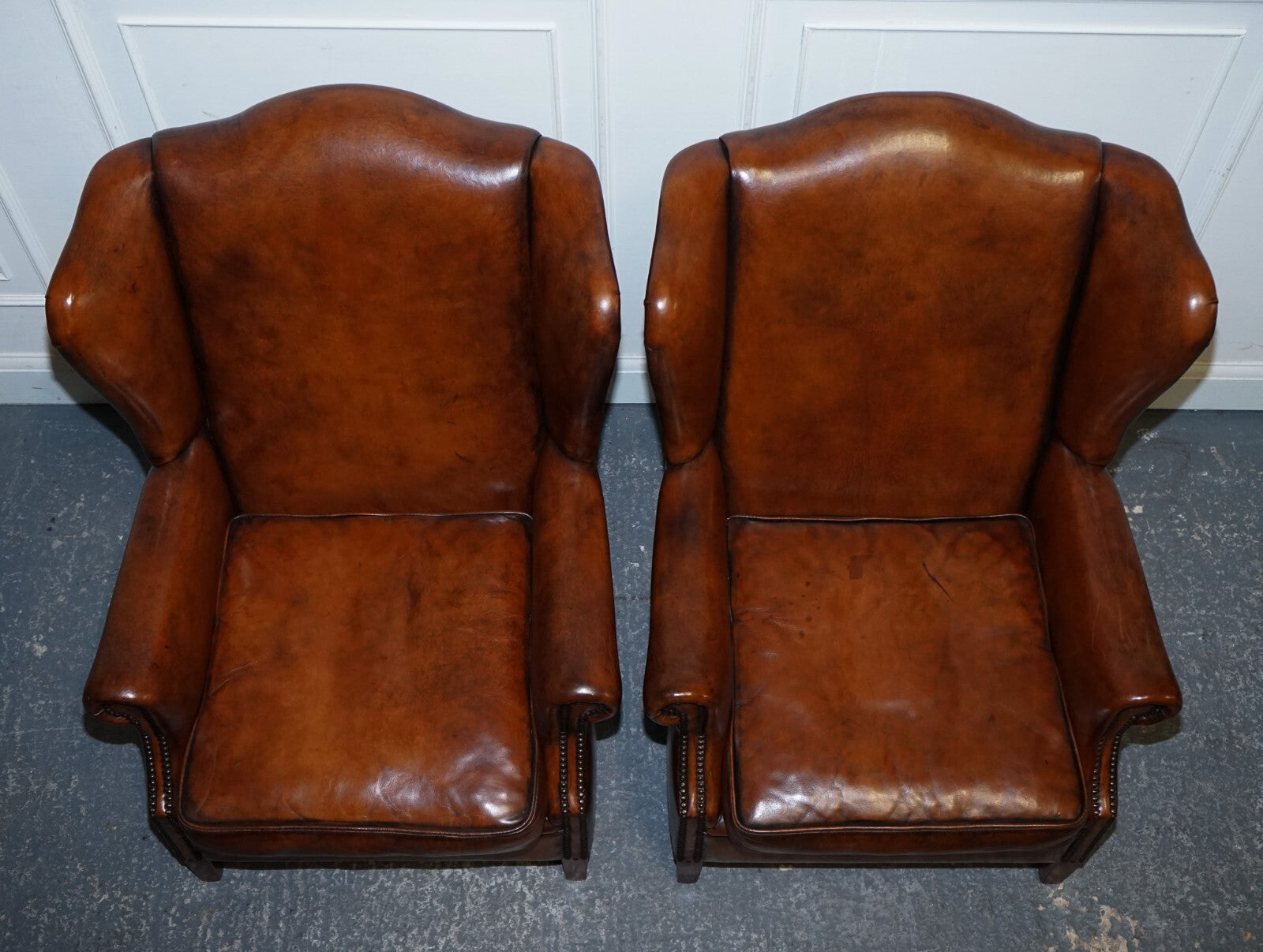 ANTIQUE PAIR OF DUTCH HAND DYED BROWN CATTLE LEATHER WINGBACK ARMCHAIRS