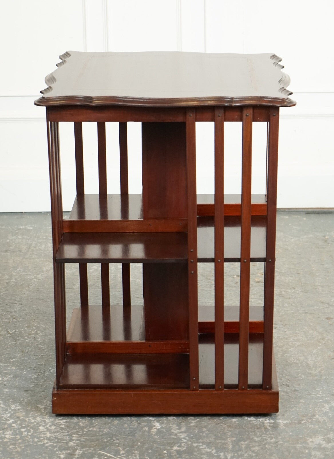 ANTIQUE EDWARDIAN REVOLVING BOOKCASE WITH A SERPENTINE SHAPED TOP