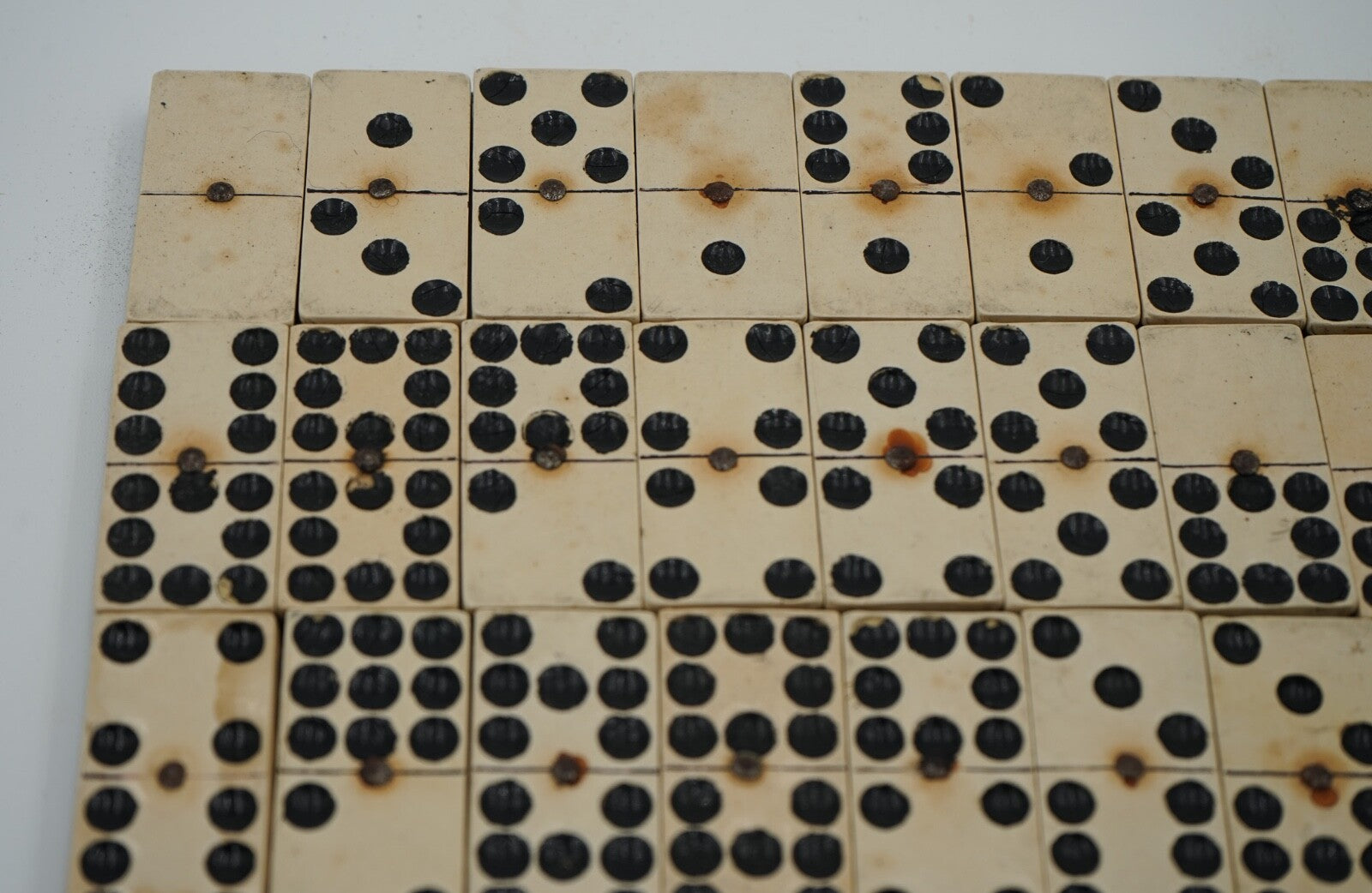 LATE 19TH CENTURY BOX OF TRADITIONAL GAME NINER DOMINOS WITH STUNNING PATINA